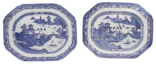 A pair of Chinese blue and white octagonal meat dishes each painted with a pagoda river landscape