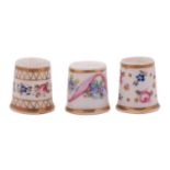 A group of three mid 19th century Derby porcelain thimbles painted with flower sprigs and gilt