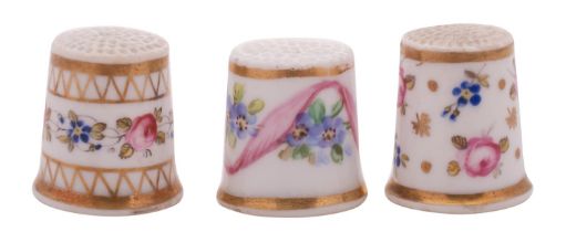 A group of three mid 19th century Derby porcelain thimbles painted with flower sprigs and gilt