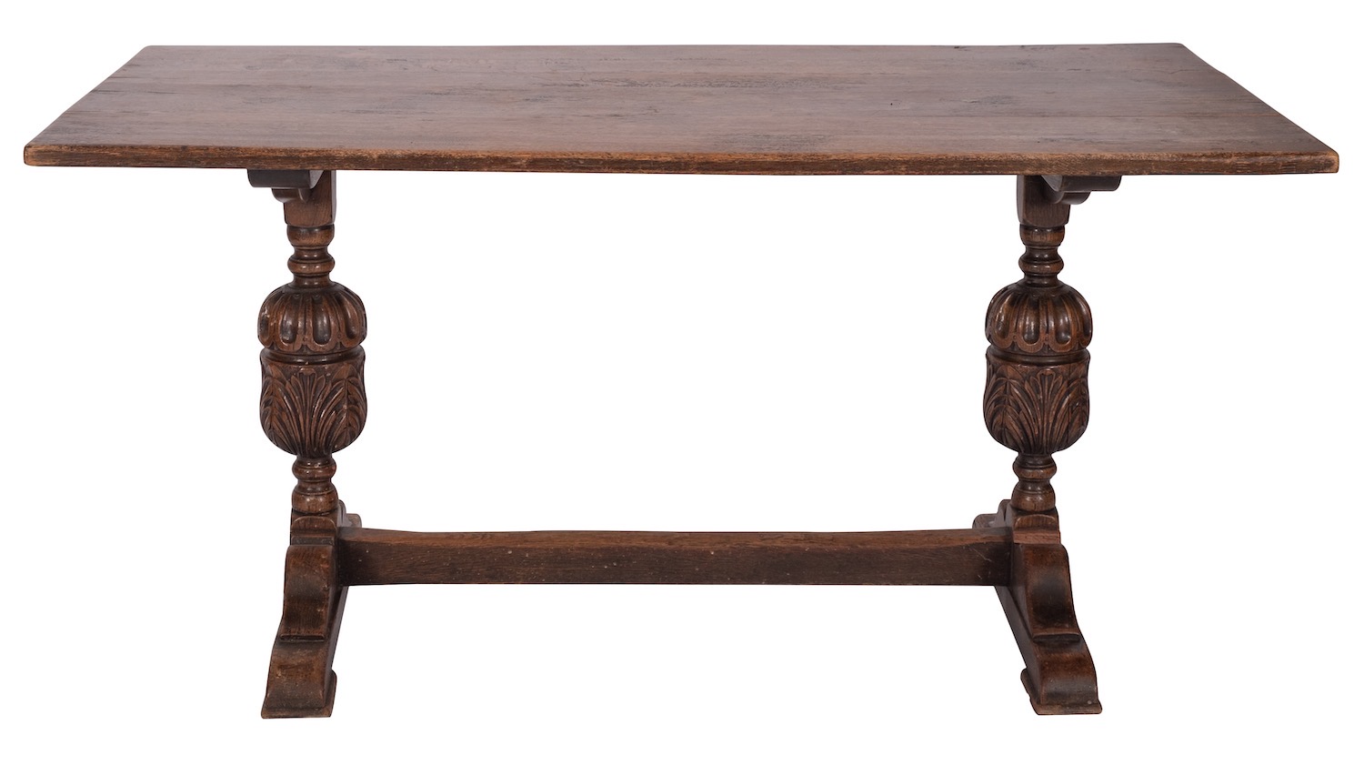 An oak trestle table in Elizabethan style, early 20th century; the rectangular top on twin knopped,