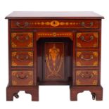 A George III mahogany and marquetry dressing table in the style of a kneehole desk,
