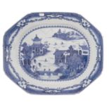 A large Chinese blue and white octagonal meat dish painted with a traditional pagoda lake landscape,