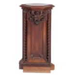 A Victorian carved and stained walnut corner plinth in Gothic taste,