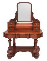 A Victorian mahogany dressing table, late 19th century; with angle adjustable shallow arched mirror,