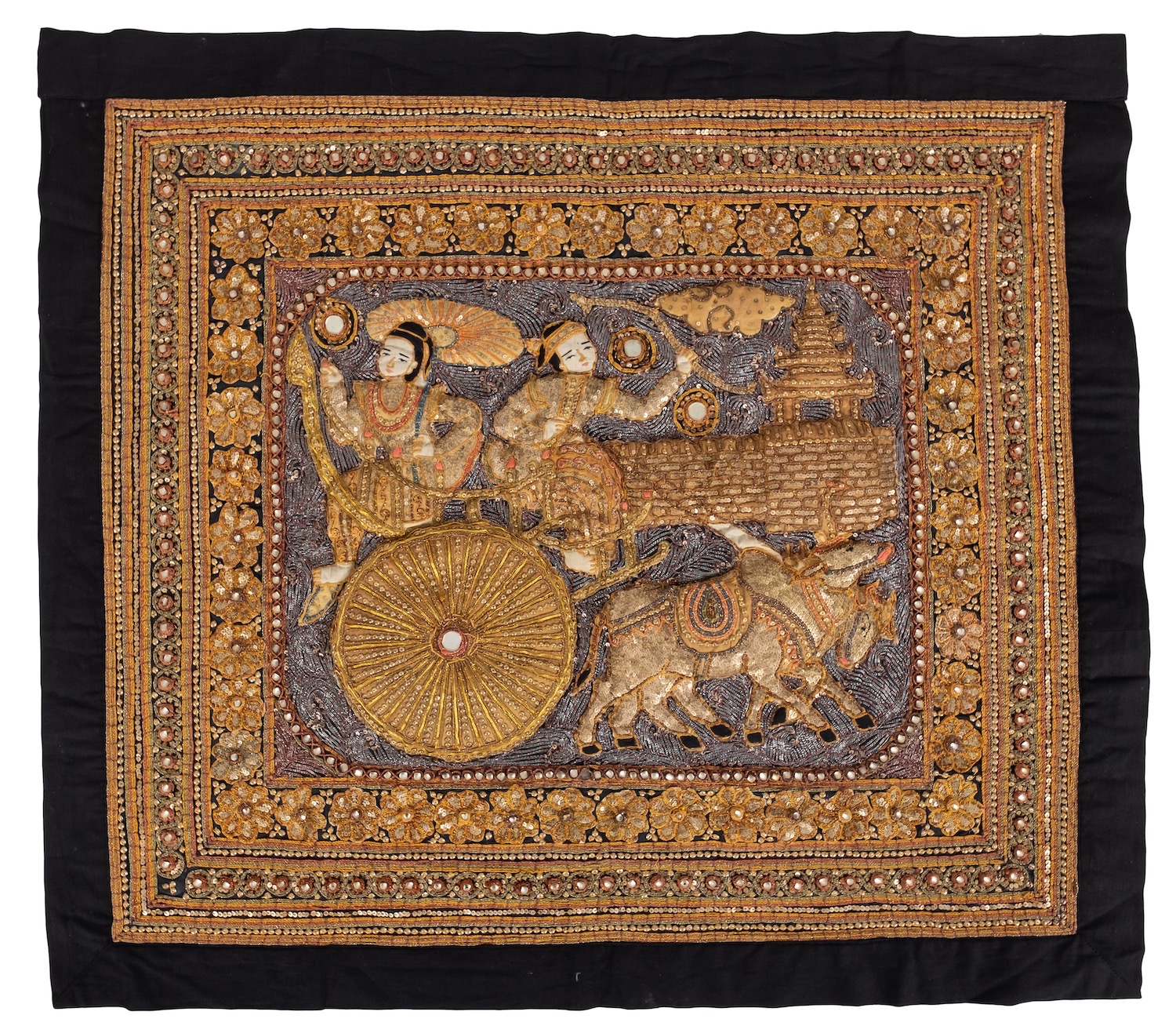 A Burmese kalaga tapestry with raised decoration depicting two figures on an ox cart,