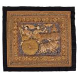 A Burmese kalaga tapestry with raised decoration depicting two figures on an ox cart,