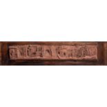 An Italian terracotta plaque, decorated in deep relief with a panoramic view of a village,