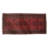 A Malayer runner, the madder field with an all over geometric design of palmettes,