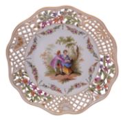 A Dresden pierced plate painted with lovers in a garden vignette within a floral swag border and
