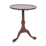 A George II mahogany circular occasional table, mid 18th century; the flip-top with moulded edges,