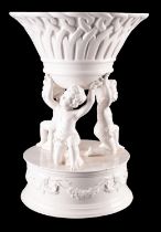 An Italian pottery centrepiece, in the form of three putti supporting a basket,