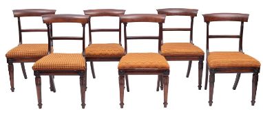 A set of six Regency rosewood dining chairs, circa 1815; each with curved and out-scrolled top rail,