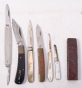 A collection of pen and folding fruit kn