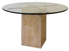 A glass topped and stone dining or centr