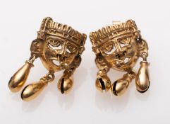 A pair of gold Inca style mask earrings