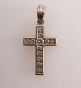 A diamond set cross in 18ct white gold,