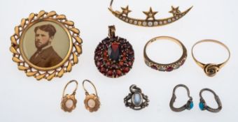 A Victorian pearl set crescent and stars, unmarked gold, a garnet cluster pendant in silver gilt,