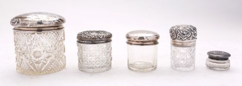 A silver topped bottle and four silver t