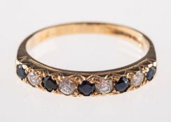 A 9ct gold and nine stone eternity ring,