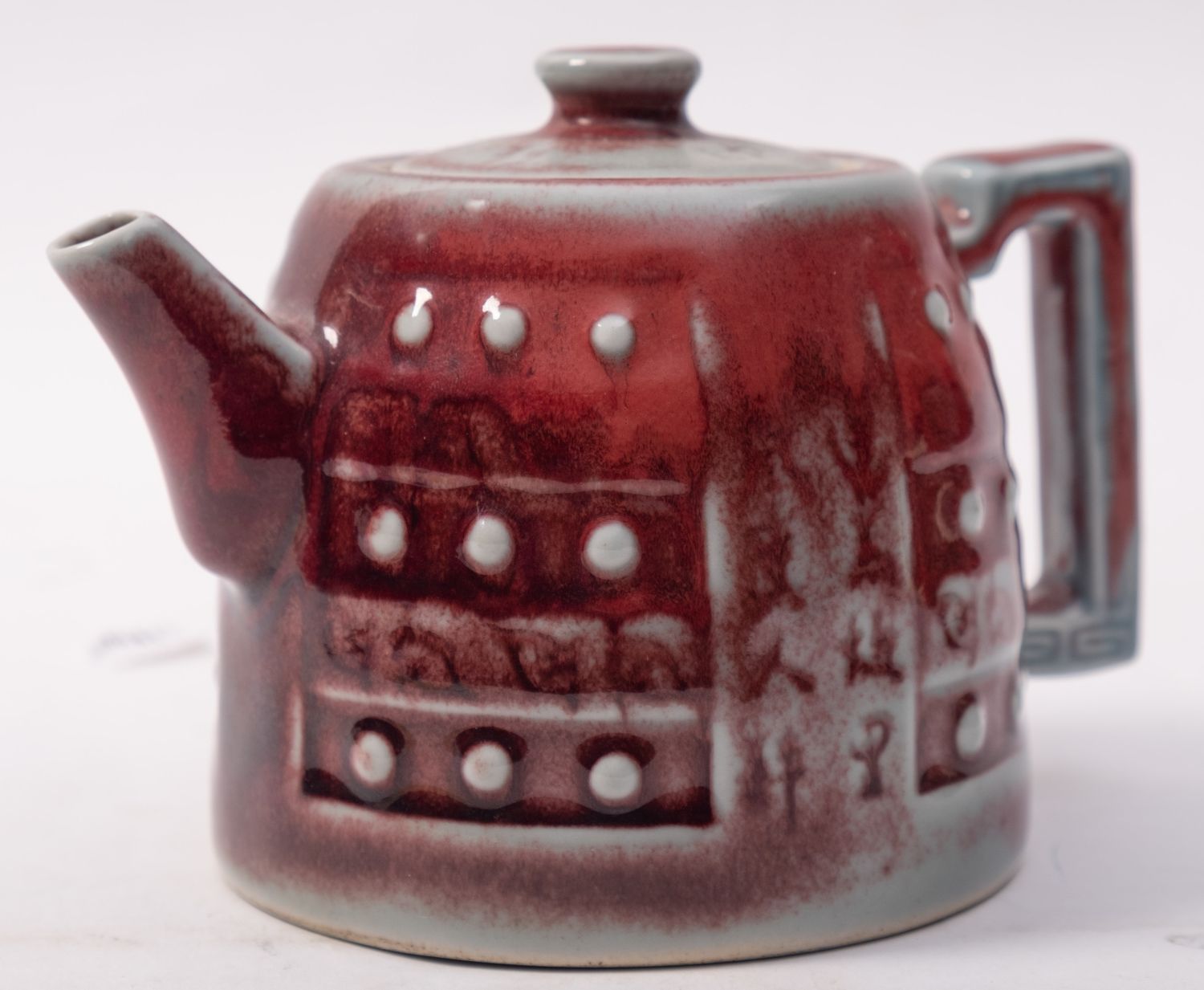 A Chinese copper red glazed teapot and c