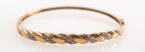 A 9ct gold diamond bangle