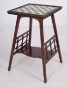 A mahogany and glazed ceramic tile inset