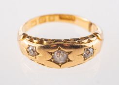 A Victorian three stone diamond ring, in 18ct gold.