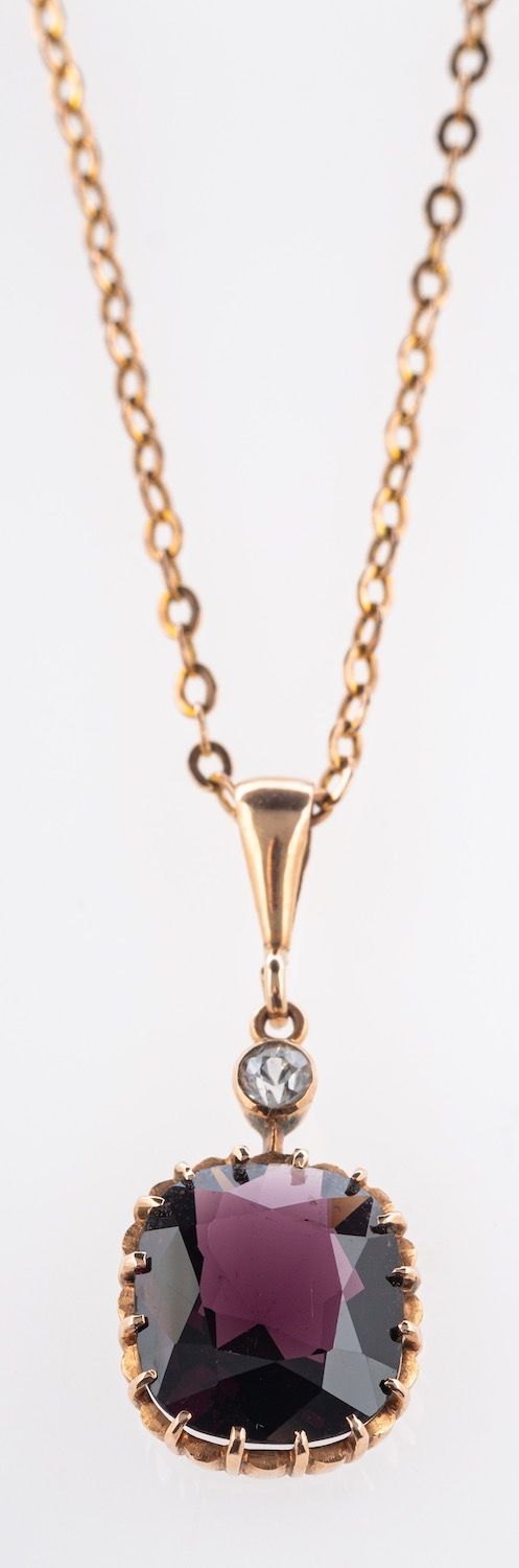 A garnet and white sapphire pendant & chain,
