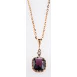 A garnet and white sapphire pendant & chain,