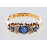 A Victorian 18ct yellow gold ring, claw set with three circular-cut sapphires,