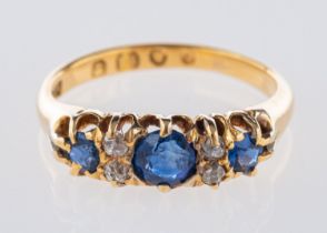 A Victorian 18ct yellow gold ring, claw set with three circular-cut sapphires,