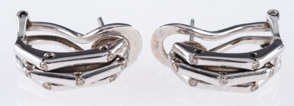 A pair half hoop earrings, made up of three strands,
