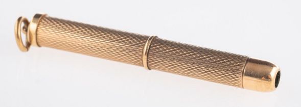 A 9ct yellow gold toothpick, with engine turned engraving, UK hallmark, length retracted approx. 4.