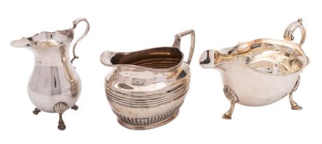 Two silver cream jugs and a sauce boat, the late Victorian oval jug by Henry Stratford,