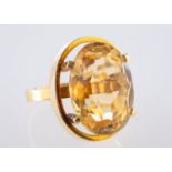 A cocktail style ring, set with an oval mixed-cut citrine, citrine approx. 18.