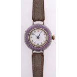 An Edwardian purple enamel and silver lady's wristwatch the round dial with black Arabic numerals