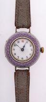 An Edwardian purple enamel and silver lady's wristwatch the round dial with black Arabic numerals