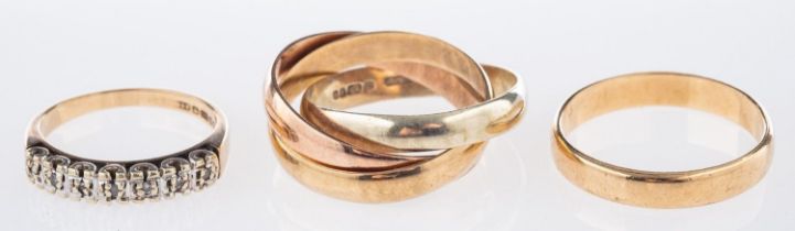 Three 9ct gold rings, including a 9ct three coloured gold Russian wedding band, UK hallmark, size S,
