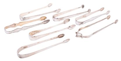 Seven George III silver sugar tongs including: one sprung pivot example with cast beaded arms