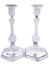A pair of Edward VII silver candlesticks by Charles & George Asprey, London 1907, of hexagon form,