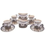 A Royal Worcester coffee service for four with silver mounts by William Comyns & Sons,