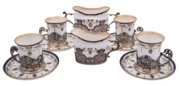 A Royal Worcester coffee service for four with silver mounts by William Comyns & Sons,
