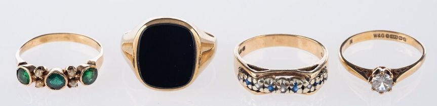 A group of four rings, including a 9ct yellow gold onyx signet ring, UK hallmark,