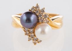 A pearl and diamond ring, set with a white and black cultured pearl and brilliant-cut diamonds,