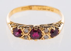 A 20th century 18ct yellow gold ring, set with three circular-cut rubies,