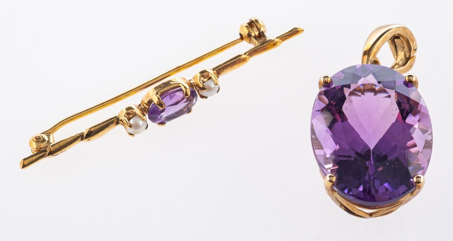 An amethyst pendant and brooch, a pendant/pearl enhancer, claw set with an oval mixed-cut amethyst,