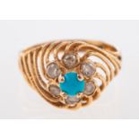 An Egyptian style ring, a high openwork twisted setting, claw set with a blue stone cabochon,