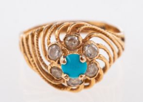 An Egyptian style ring, a high openwork twisted setting, claw set with a blue stone cabochon,