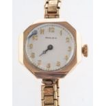 Rolex a 9ct gold lady's wristwatch the round cream dial with raised Arabic numerals and moon hands,