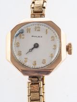 Rolex a 9ct gold lady's wristwatch the round cream dial with raised Arabic numerals and moon hands,